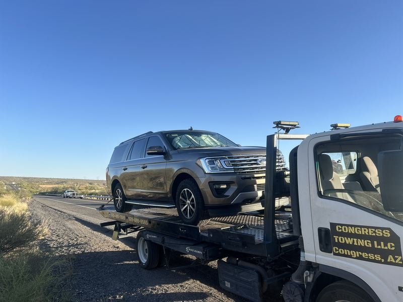 Early-morning SUV tow on the highway