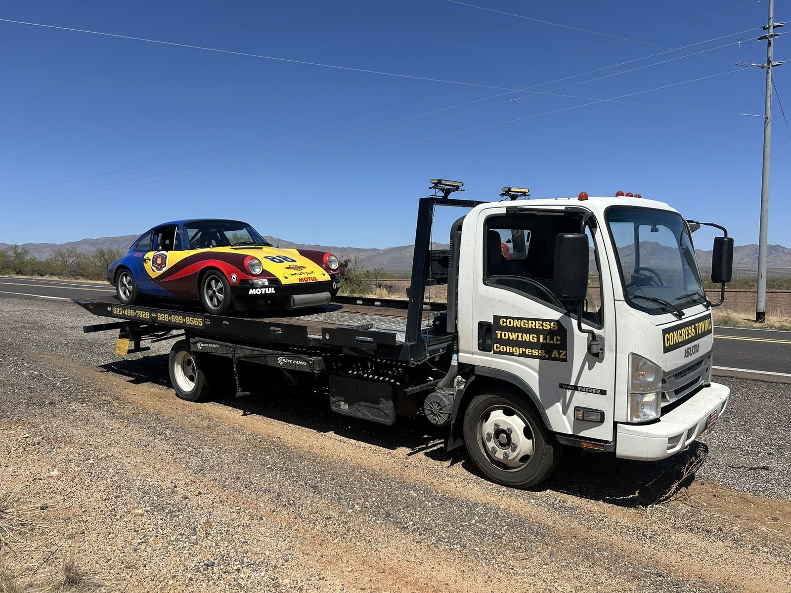 Congress Towing flatbed hauling a vehicle on an Arizona highway